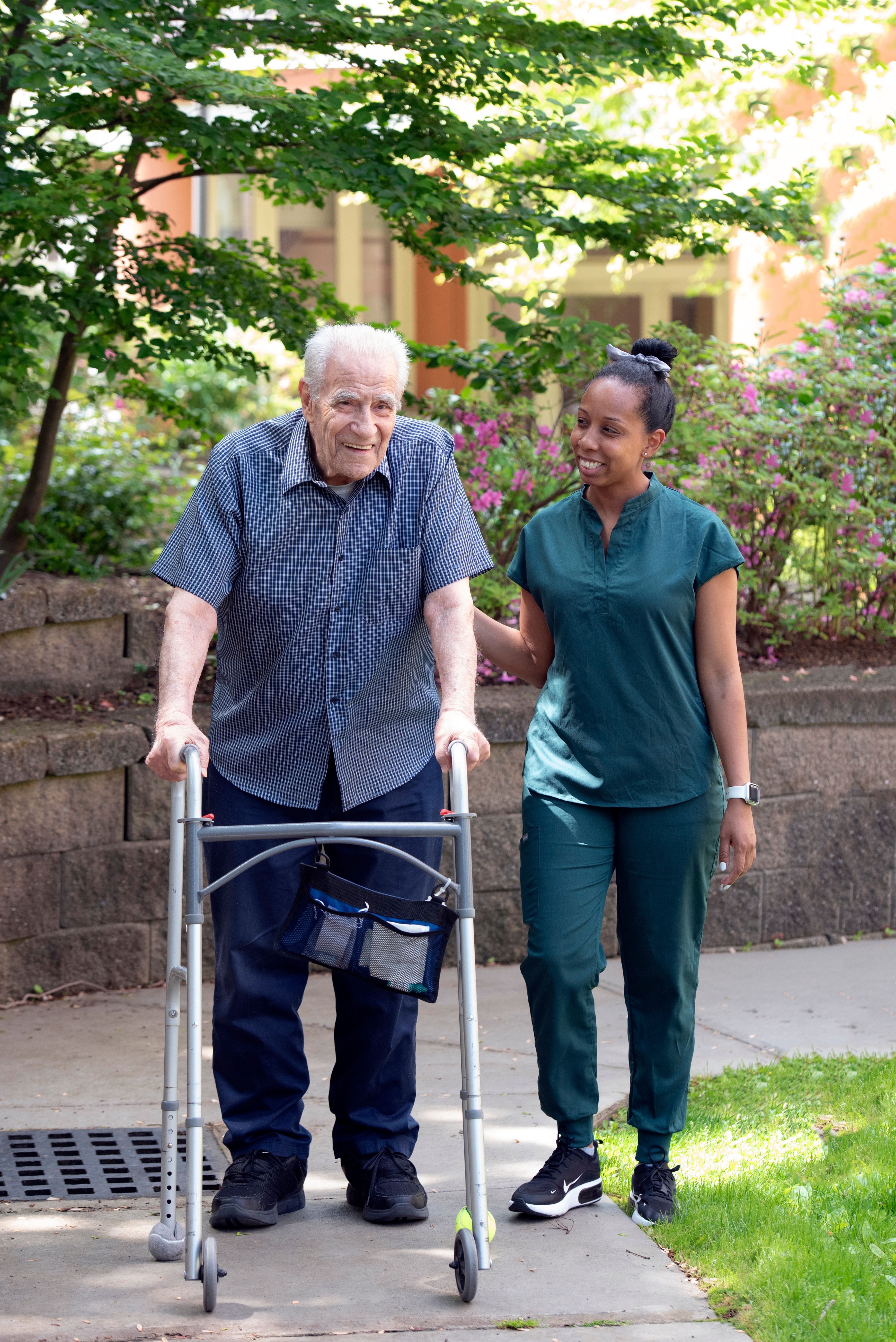 Man With His Walker and Nurse Helping Him